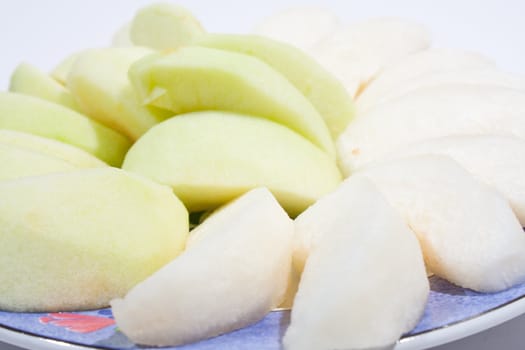 Apples, peeled and wheat. Sort palatable Arranged on the plate insert. On a white background.