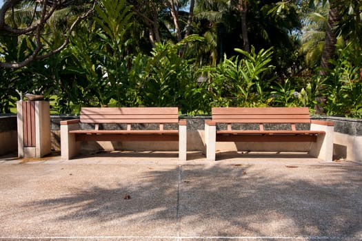 Wooden bench in the park on your holiday tree shade.