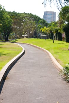 Winding path ahead is a tall building. Destination with huge winding path.