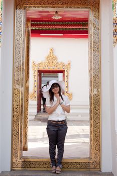 smiling young thai girl and white hat travel in temple thai