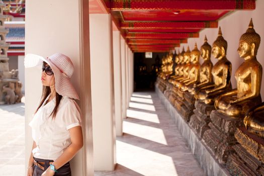 smiling young thai girl and white hat travel in temple thai