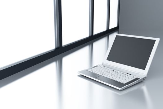 laptop on a smooth surface and light from a window