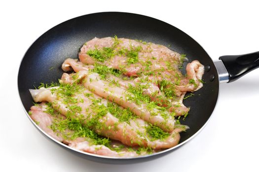 Raw chicken meat on a frying pan ready for a frying