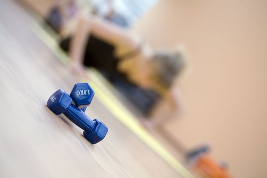 blue dumbbells in a modern hall for sports trainings