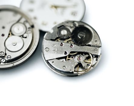 Old metal mechanical clock with gear wheels on a white background