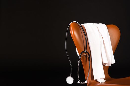 A doctors stethoscope hanging over a chair.