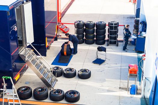 JEREZ DE LA FRONTERA, SPAIN - FEB 06: Mechanics of the team Toro Rosso preparing pneumatic tires Pirelli  for the start of the trainings on February 06 , 2012, in Jerez de la Frontera , Spain