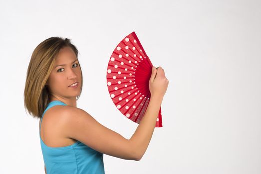 Woman fighting summer heat with a traditional fan
