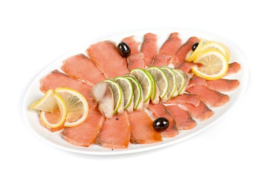 Sliced chum salmon and mackerel decorated with limes, lemons and olives isolated on white