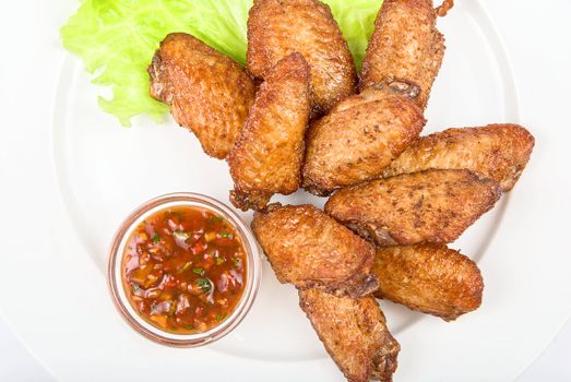 chicken roasted wing dish with sauce on a white background