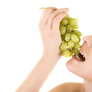 Closeup of woman mouth with green grape on a white