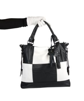 Black and white women bag at hand isolated on white background