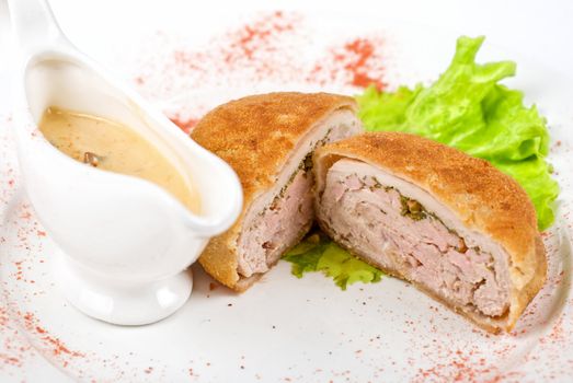 Beef cutlet closeup stuffed with bacon on white plate