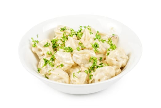 meat dumplings with greens on a white