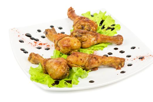 chicken wings closeup at white plate with lettuce