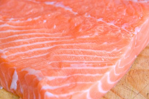 salmon closeup slice at wooden board