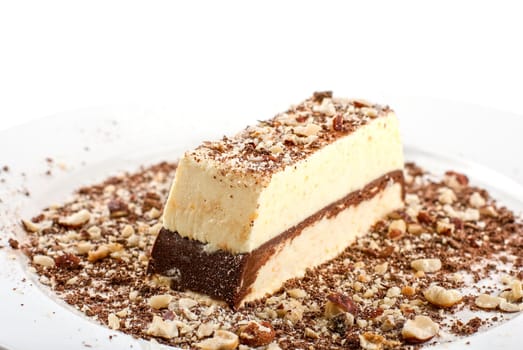 Slice of chocolate cake with nuts isolated on white