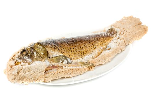 Fish carp baked with bay salt closeup