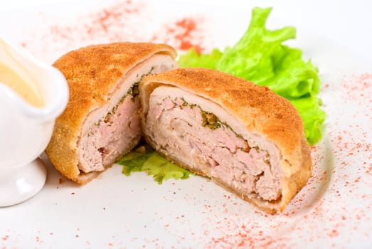 Beef cutlet closeup stuffed with bacon on white plate