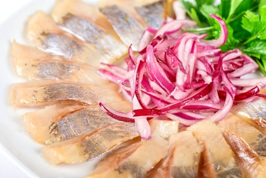 Marinated herring fillets closeup with onion