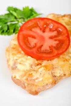 Roasted pork steak baked with cheese and tomato