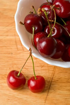 ripe cherries on the wood table