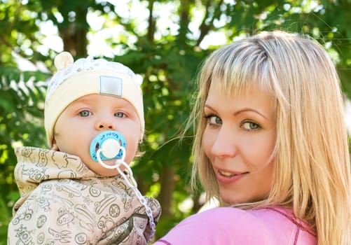 happy mum and her boy outdoor portrait