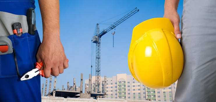 Closeup of workers with instruments on building background