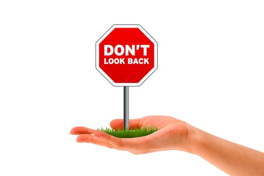 Hand holding stop sign with the words Don't look Back. 
