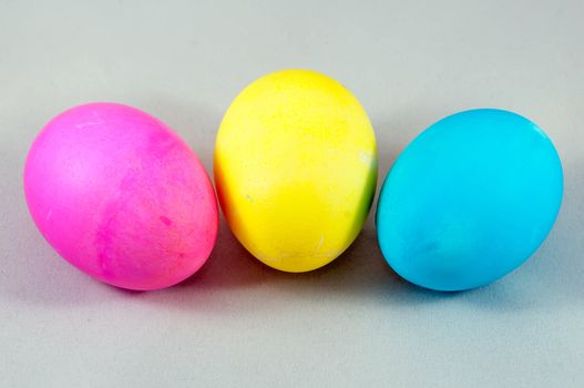 three easter eggs pink  blue yellow