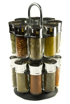 different spices rolling set in glass jars on wooden mat