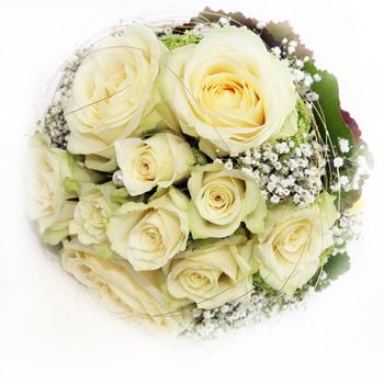Delicate circular bridal bouquet of beautiful white roses on a white background