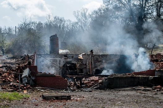 residential house ruins after fire still smoking