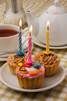 cake with a candle and tea drinking