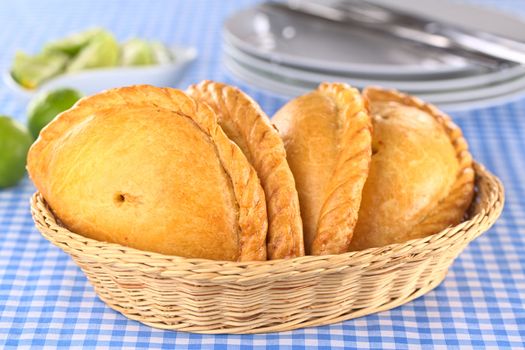 Peruvian snacks called Empanadas (pies) filled with chicken and beef (Selective Focus, Focus on the right part of the front empanada)