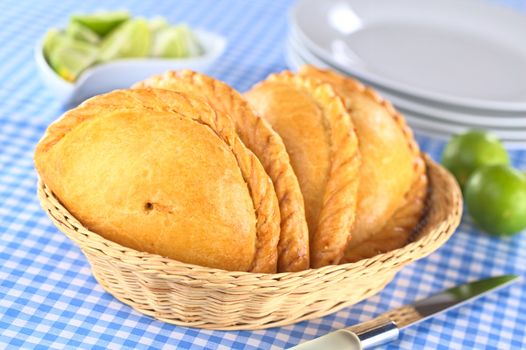 Peruvian snacks called Empanadas (pies) filled with chicken and beef (Selective Focus, Focus on the middle of the front empanada)