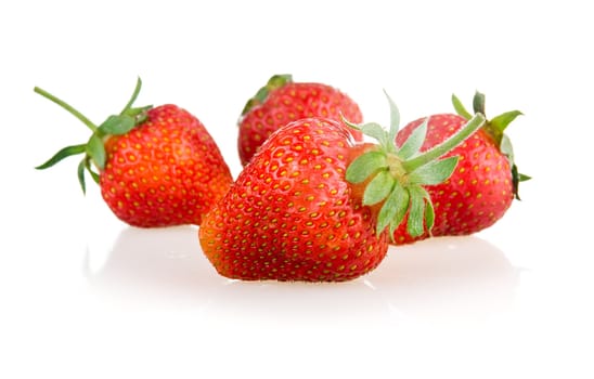 Red strawberry fruits with green leaves isolated on white background 