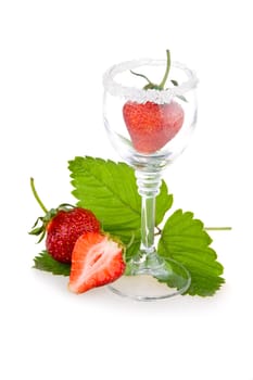 Red strawberry fruits with green leaves in glass isolated on white background 