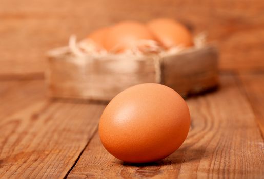 fresh brown eggs on wooden background