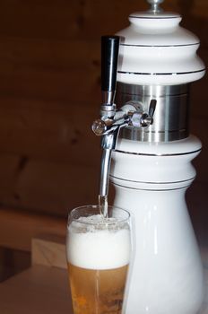closeup of fresh beer pouring from a tap