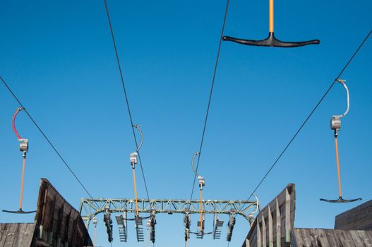 Detail of T-bar ski lift (drag lift) against great bkue sky