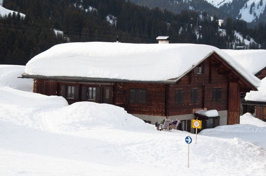 Small wooden huts covered with a lot of fresh snow in Montafon, Austria