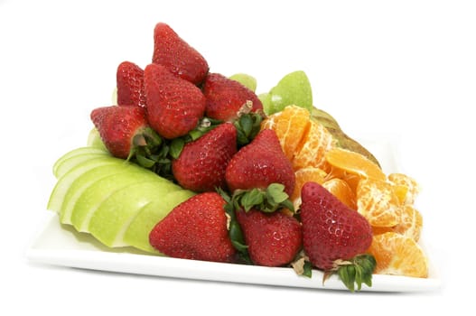 a large plate of sliced fruit on white background