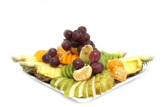 a large plate of sliced fruit on white background