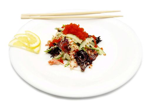 salad with caviar on a plate with chopsticks