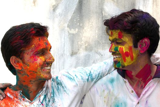 Two friends enjoying the colorful holi festival in India.