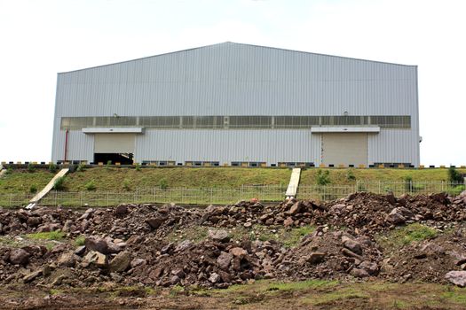 A structure of an industrial factory shed on a hill, in India.