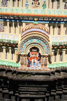 A beautiful idol of lord dattatreya also known as gurudatta or dattaguru, on an ancient temple dome.