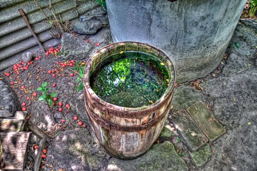 Wooden barrel with water near the well fall HDR