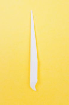 White toothpick on a yellow background close up